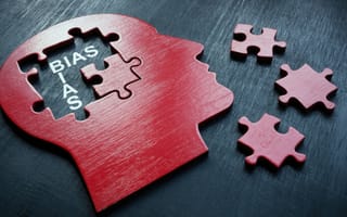 A puzzle of a head with missing pieces revealing unconscious bias.